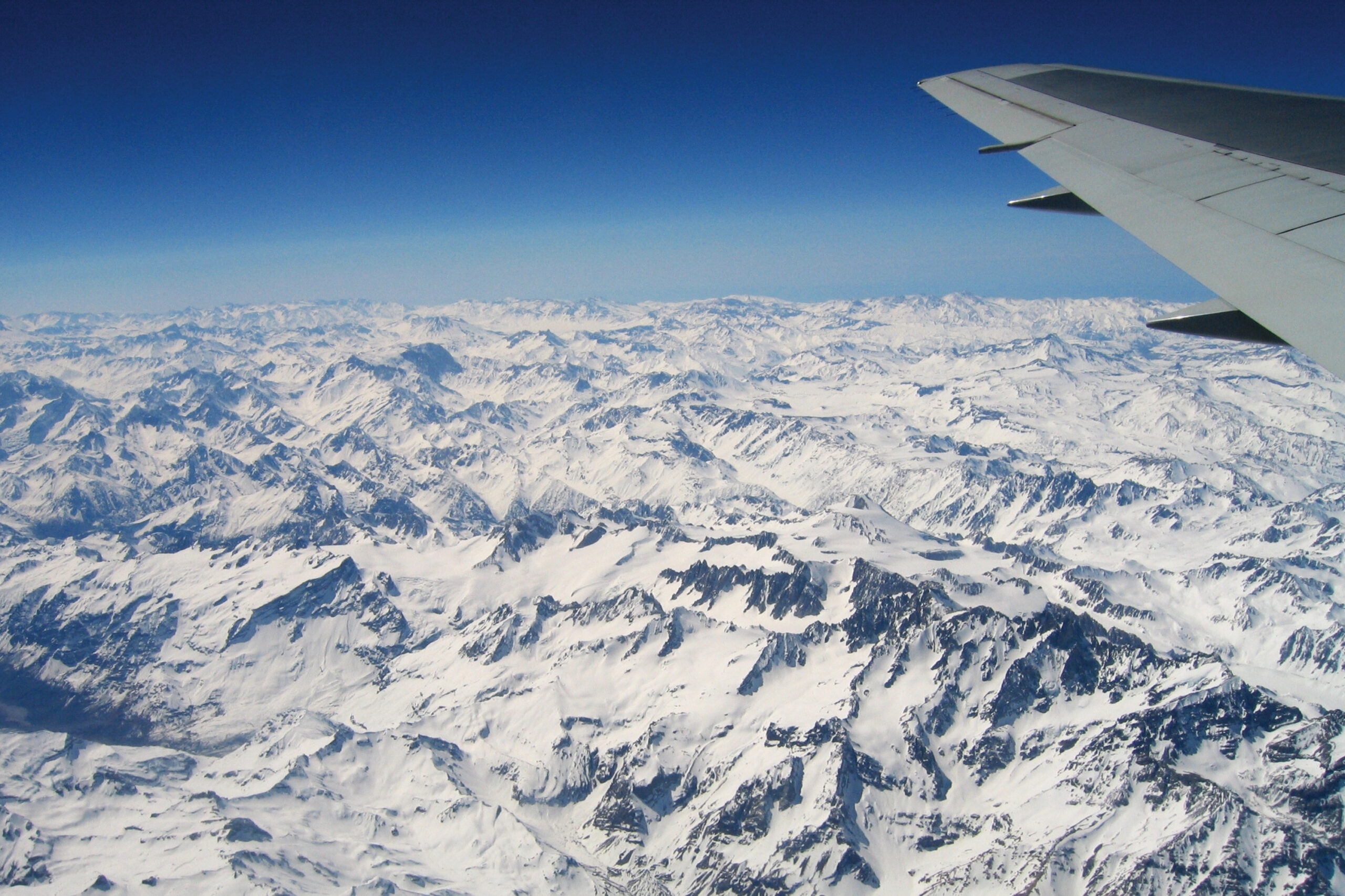 Repatriation Planning for Expats blog photo showing a plane wing over the Swiss alps